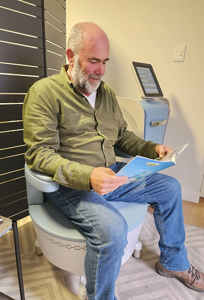 A man sitting on a Pelvic Care Chair